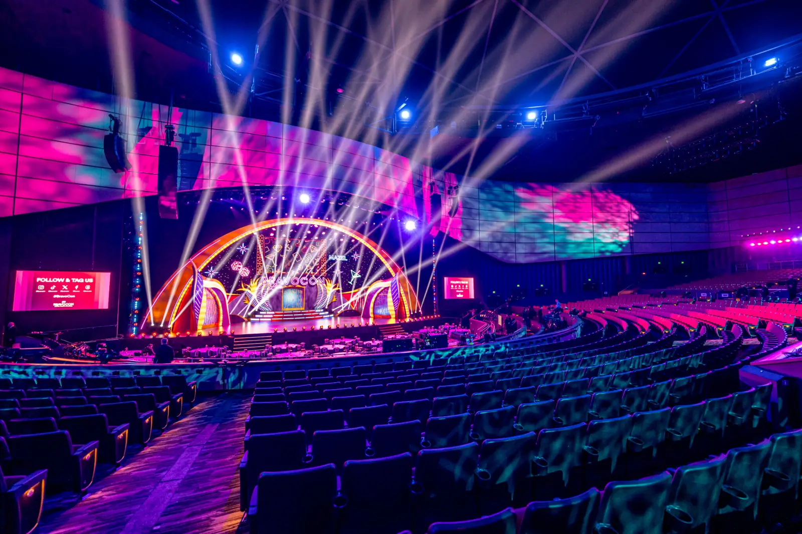 The BravoCon 2025 main stage lit in purple and pink before a show