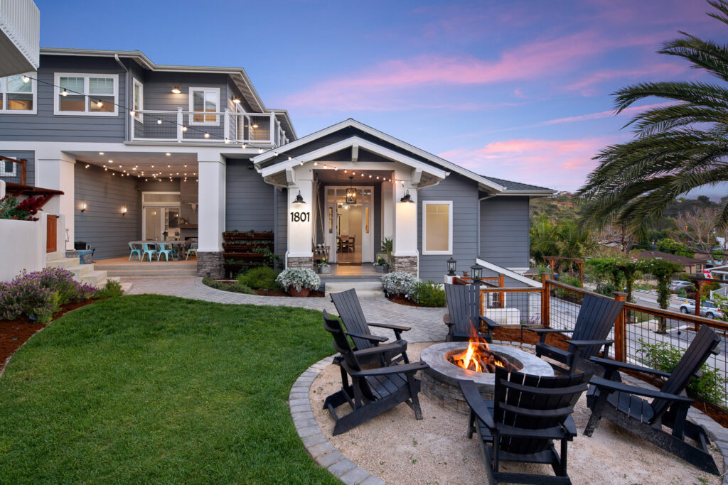 Exterior of a home with showcasing a fire put at twilight