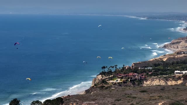 Paragliders flying over La Jolla Shores La Jolla Farms Black’s Beach and Torrey Pines on a beautiful afternoon | Drone Video