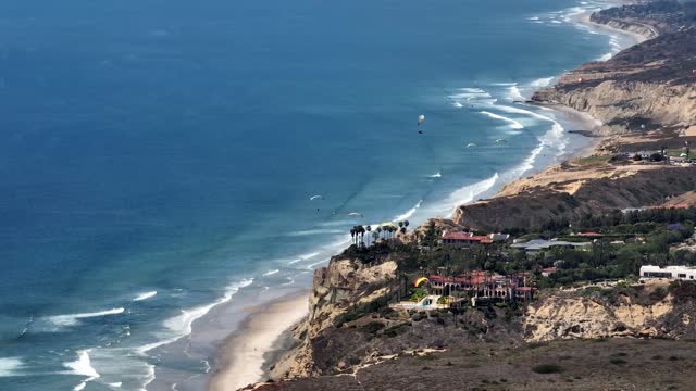 Paragliders flying over La Jolla Shores La Jolla Farms Black’s Beach and Torrey Pines on a beautiful afternoon | Drone Video – 1