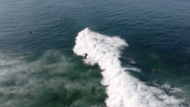 Surfer at Windansea Beach and Beach Barber tract in San Diego on a beautiful Monring | Drone Video
