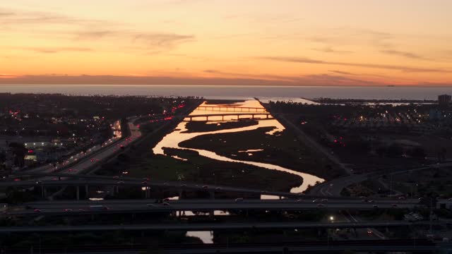 Looking out over the San Diego River towards Mission Beach Mission Bay and Ocean Beach during Sunset | Drone Video