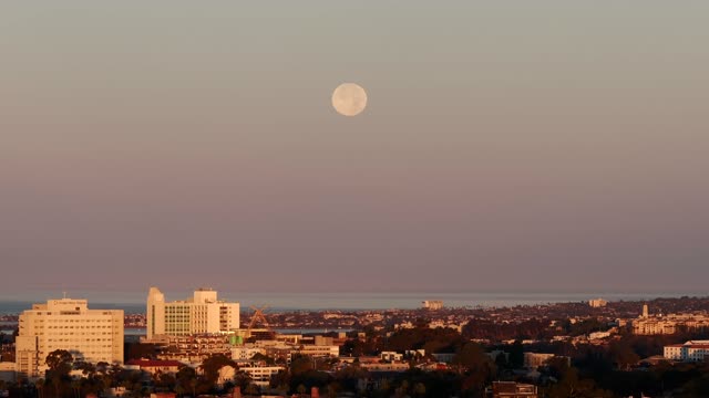 A view of the Full Moon over San Diego Mission Beach Mission Bay and the ocean from North Park | Drone Video – 1