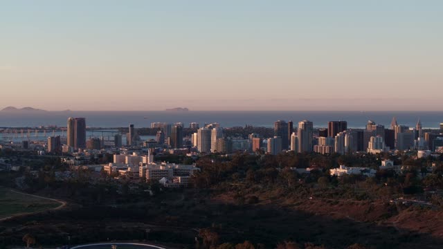 A view of Downtown San Diego and Point Loma from North Park during Sunrise | Drone Video