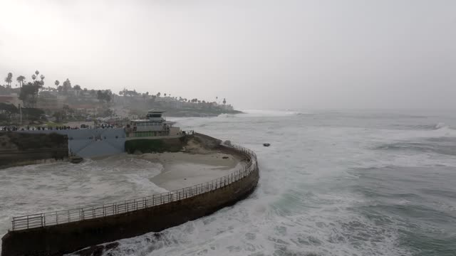 A Stormy and Cloudy day in La Jolla San Diego with big waves at Children’s Pool | Drone Video